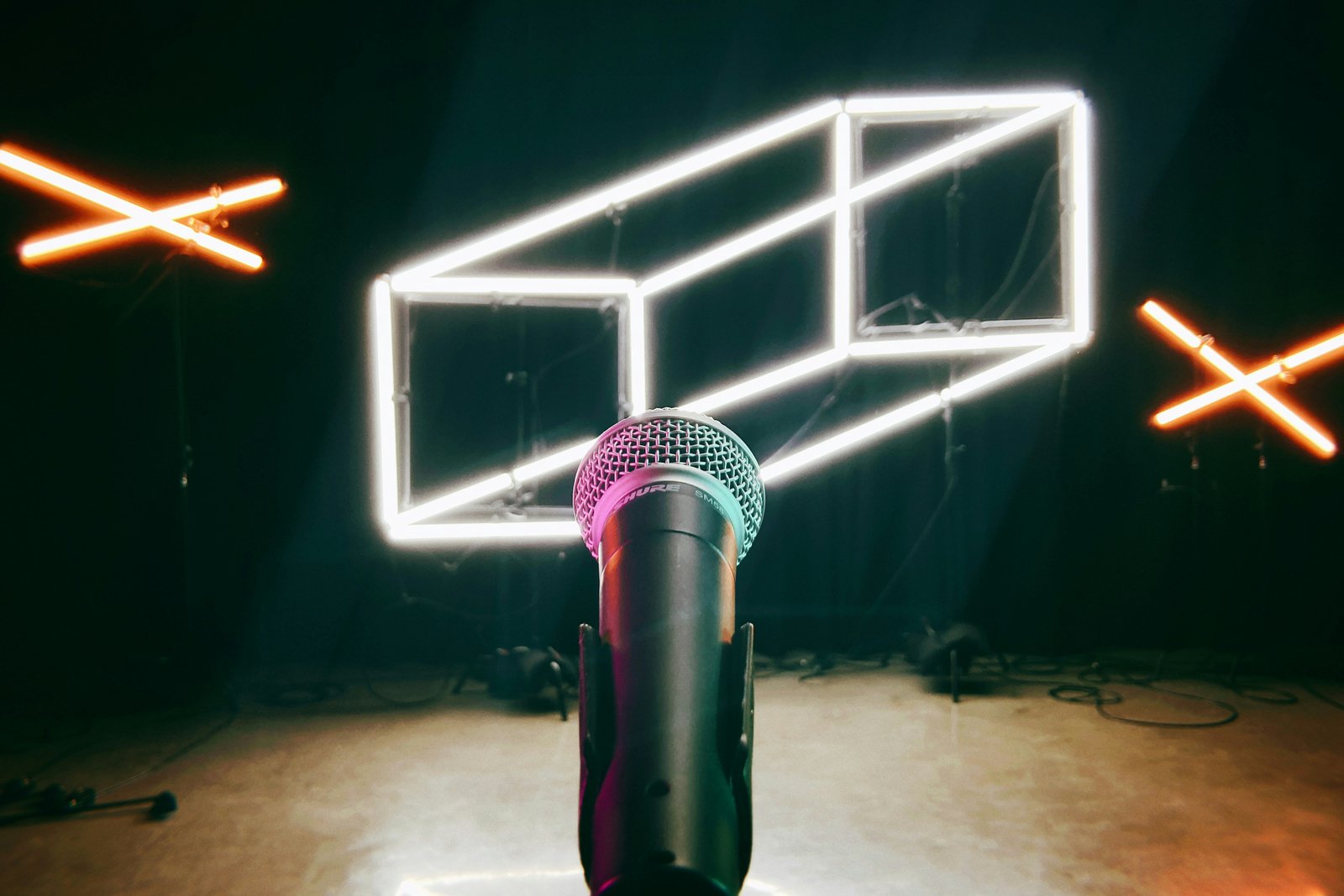 a microphone in a dark room with neon lights